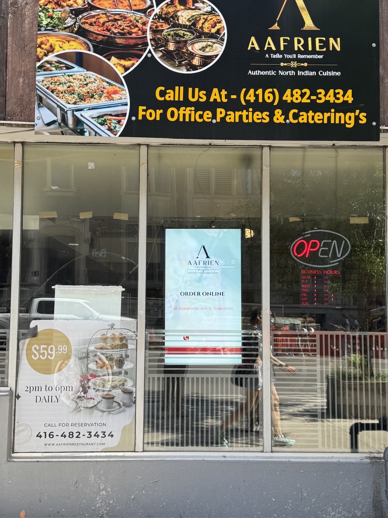 Digital window screen running an ad in a Yonge and Eglinton restaurant window